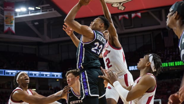 Dec 1, 2021; Fayetteville, Arkansas, USA; Arkansas Razorbacks guard Khalen Robinson (2) tries to block a shot by Central Arkansas Bears guard Camren Hunter (23) during the first half at Bud Walton Arena. Mandatory Credit: Brett Rojo-USA TODAY Sports